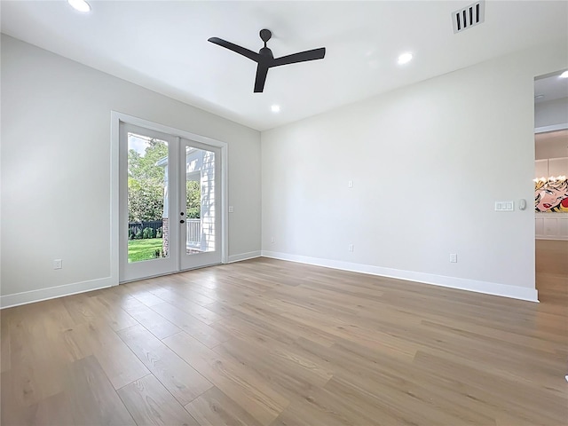 spare room featuring visible vents, light wood-style flooring, ceiling fan, and baseboards