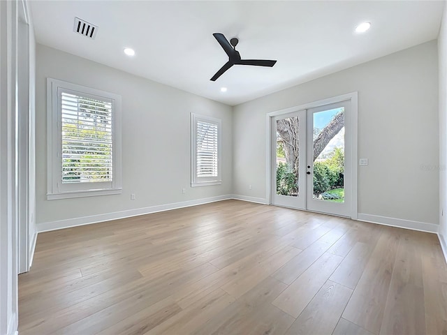 empty room featuring visible vents, baseboards, plenty of natural light, and ceiling fan
