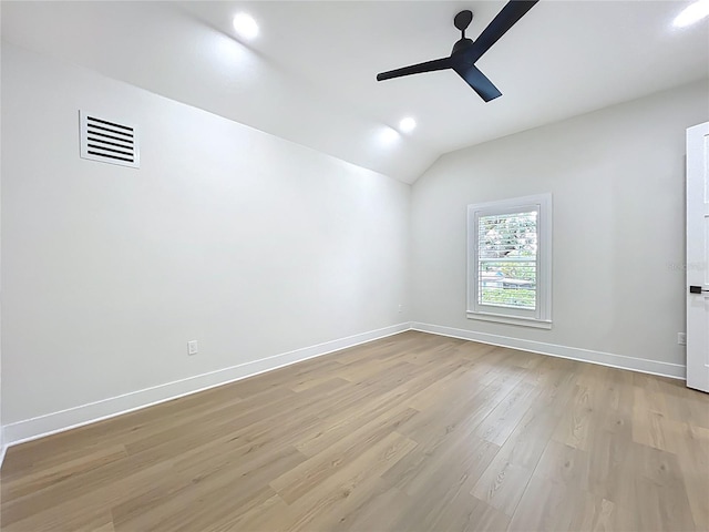unfurnished room with a ceiling fan, visible vents, baseboards, lofted ceiling, and light wood-style flooring