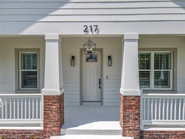 view of exterior entry featuring a porch