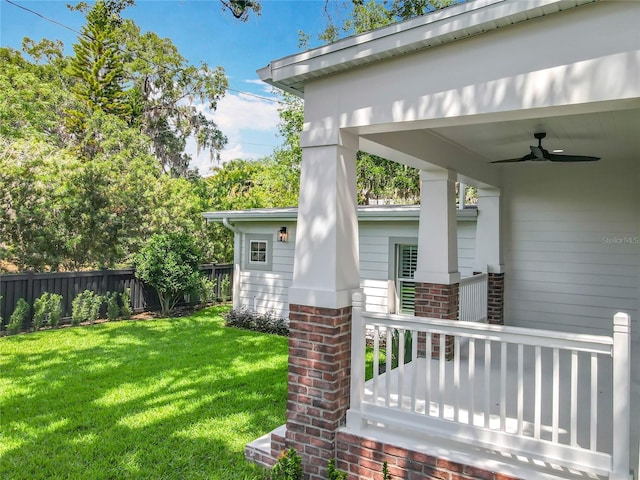 view of yard with fence and a ceiling fan