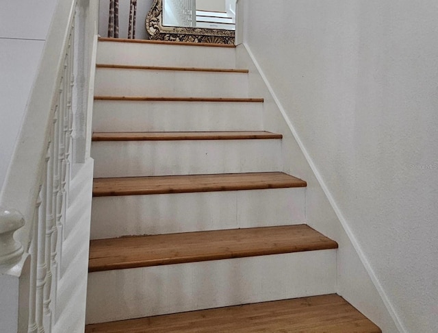 staircase featuring wood finished floors