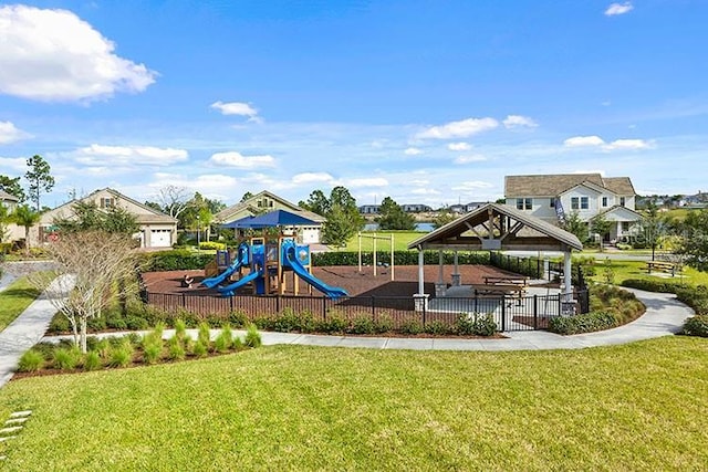 community jungle gym with a lawn, a gazebo, and fence