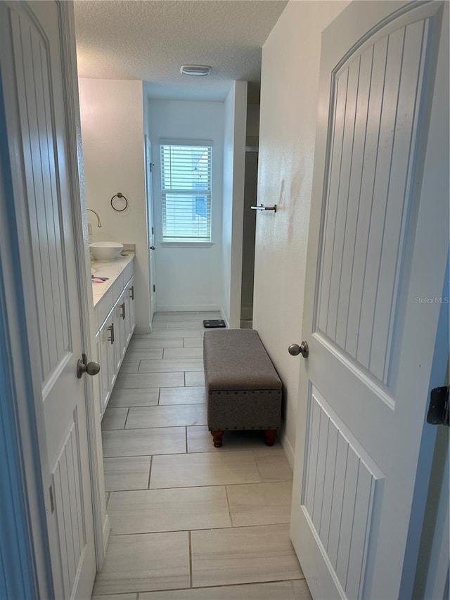 15929 Moonlight Bay St, Winter Garden, FL 34787 - bathroom with vanity, a textured ceiling, and wood tiled floors