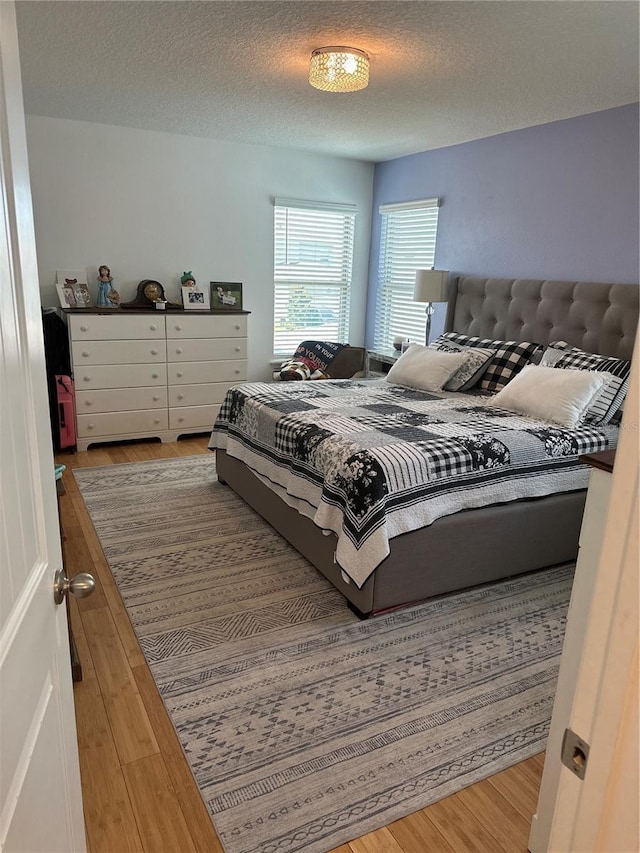 15929 Moonlight Bay St, Winter Garden, FL 34787 - bedroom featuring wood finished floors and a textured ceiling