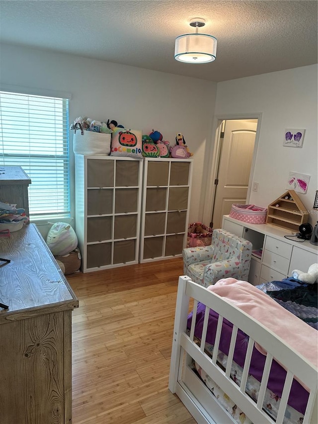 15929 Moonlight Bay St, Winter Garden, FL 34787 - bedroom featuring light wood-type flooring and a textured ceiling