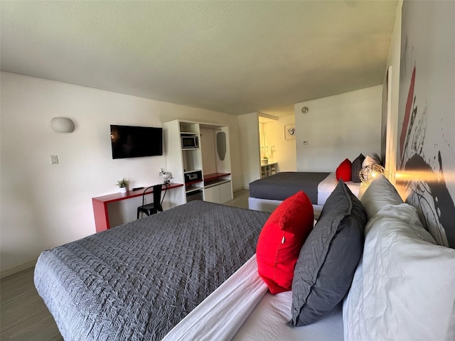 5245 W Irlo Bronson Memorial Hwy Unit 276, Kissimmee, FL 34746 - bedroom with baseboards and wood finished floors