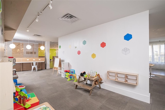 5245 W Irlo Bronson Memorial Hwy Unit 276, Kissimmee, FL 34746 - recreation room featuring track lighting, baseboards, carpet flooring, and visible vents
