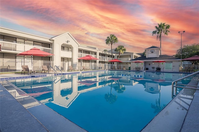 5245 W Irlo Bronson Memorial Hwy Unit 276, Kissimmee, FL 34746 - pool at dusk featuring a community pool, a patio area, and fence