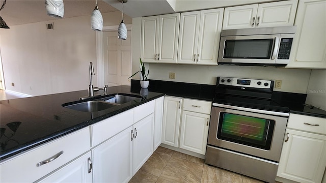 3235 Candle Ridge Dr Unit 102, Orlando, FL 32822 - kitchen with a sink, stainless steel appliances, white cabinetry, and visible vents