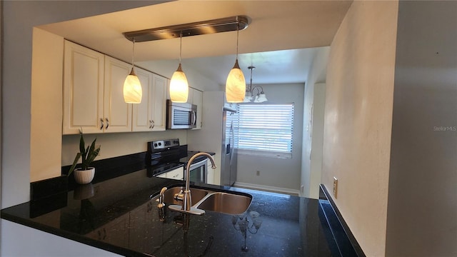 3235 Candle Ridge Dr Unit 102, Orlando, FL 32822 - kitchen with decorative light fixtures, appliances with stainless steel finishes, a sink, baseboards, and white cabinets