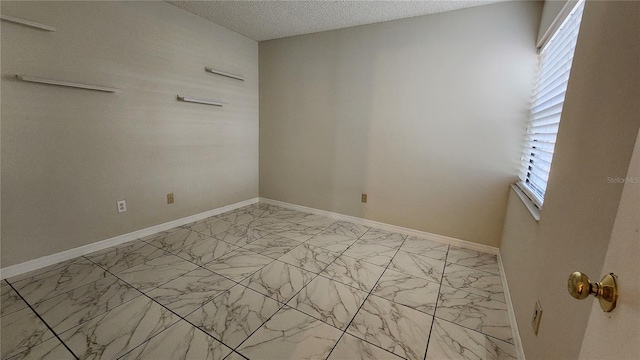 3235 Candle Ridge Dr Unit 102, Orlando, FL 32822 - unfurnished room featuring baseboards, a textured ceiling, and marble finish floor