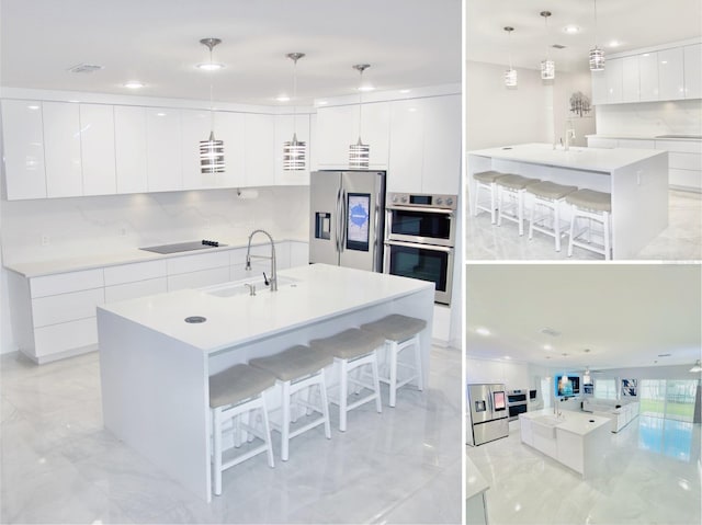 247 Whispering Pines Way, Davenport, FL 33837 - kitchen featuring modern cabinets, appliances with stainless steel finishes, a sink, a large island, and a breakfast bar