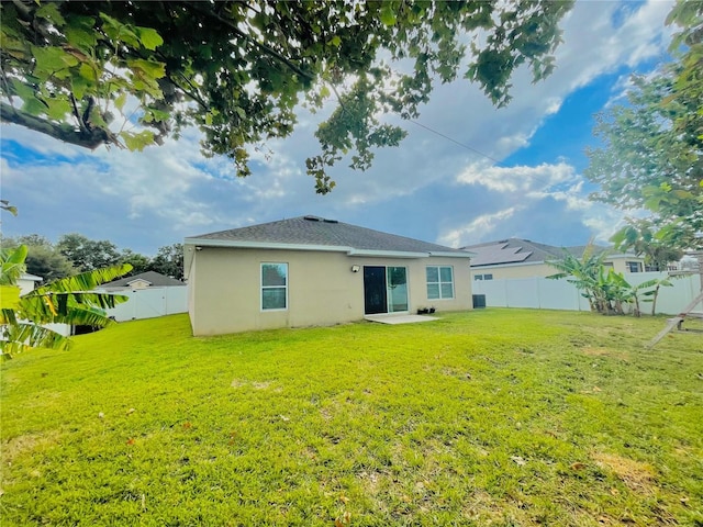 247 Whispering Pines Way, Davenport, FL 33837 - back of house with stucco siding and a patio