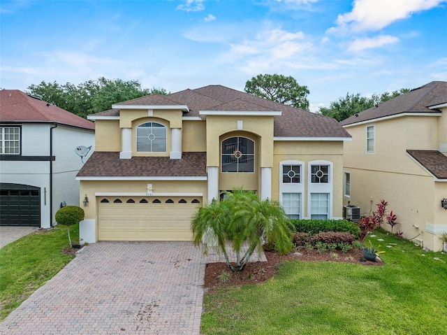 5321 Los Palma Vista Dr, Orlando, FL 32837 - mediterranean / spanish home featuring a garage, a shingled roof, a front lawn, and stucco siding