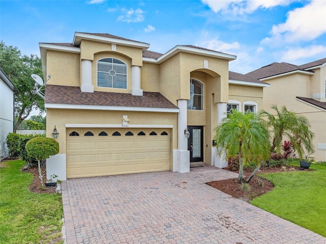 5321 Los Palma Vista Dr, Orlando, FL 32837 - mediterranean / spanish home with an attached garage, decorative driveway, stucco siding, and a front yard