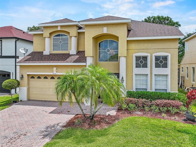 5321 Los Palma Vista Dr, Orlando, FL 32837 - mediterranean / spanish-style house with a garage, stucco siding, and a shingled roof