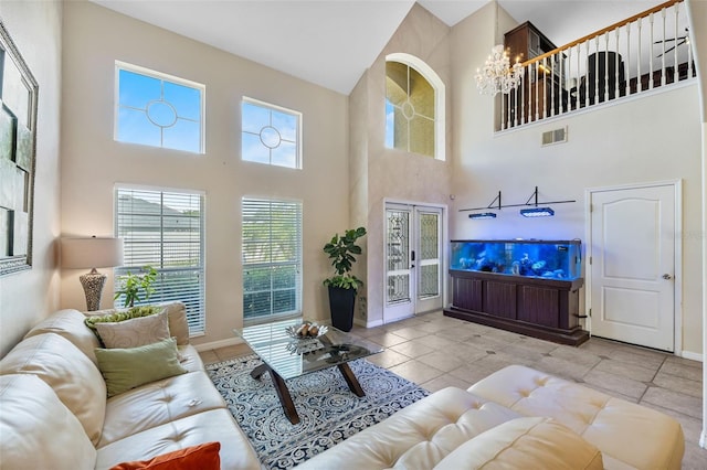 5321 Los Palma Vista Dr, Orlando, FL 32837 - living area featuring an inviting chandelier, baseboards, a towering ceiling, and visible vents
