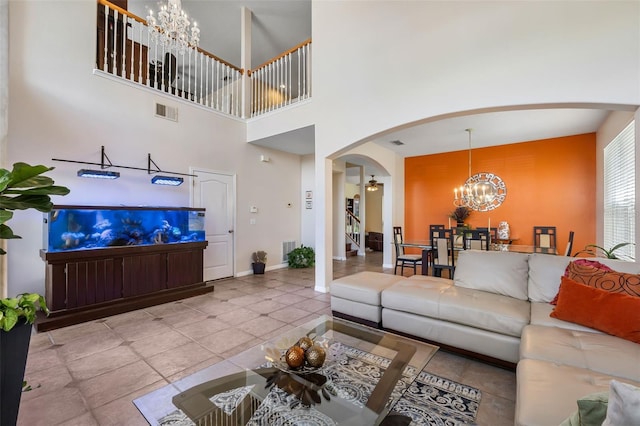 5321 Los Palma Vista Dr, Orlando, FL 32837 - tiled living room featuring arched walkways, baseboards, a notable chandelier, and visible vents