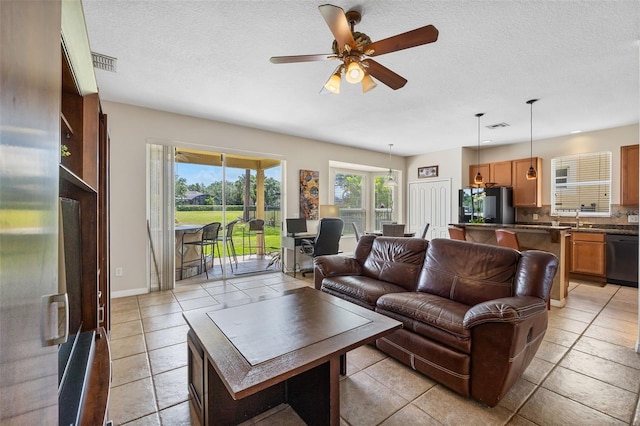 5321 Los Palma Vista Dr, Orlando, FL 32837 - living room with a ceiling fan, a textured ceiling, visible vents, and baseboards