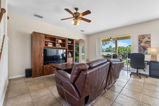 5321 Los Palma Vista Dr, Orlando, FL 32837 - living area with arched walkways, a textured ceiling, a ceiling fan, baseboards, and visible vents