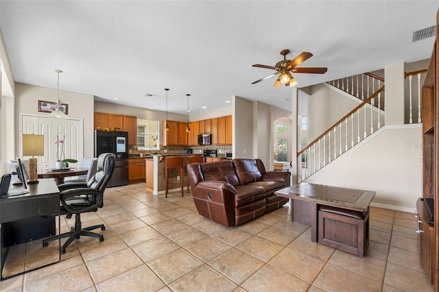 5321 Los Palma Vista Dr, Orlando, FL 32837 - living room with plenty of natural light, a ceiling fan, light tile patterned flooring, and visible vents