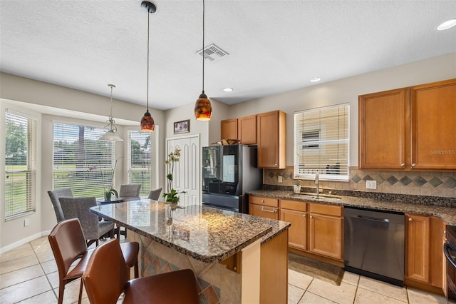 5321 Los Palma Vista Dr, Orlando, FL 32837 - kitchen featuring a sink, dishwasher, light tile patterned floors, refrigerator with glass door, and visible vents