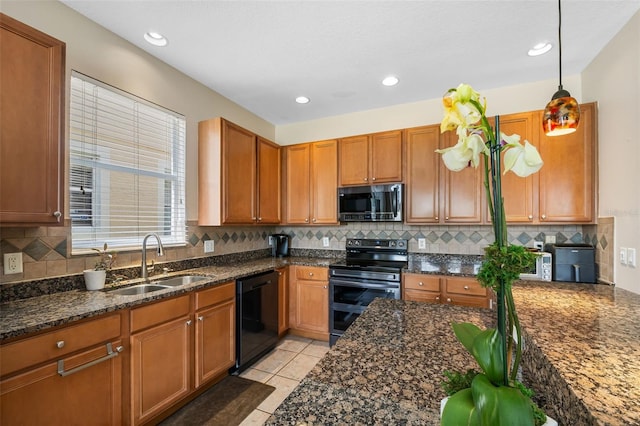 5321 Los Palma Vista Dr, Orlando, FL 32837 - kitchen with a sink, decorative backsplash, appliances with stainless steel finishes, and dark stone counters