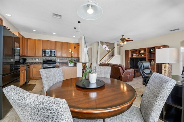 5321 Los Palma Vista Dr, Orlando, FL 32837 - dining room featuring ceiling fan, light tile patterned flooring, and visible vents