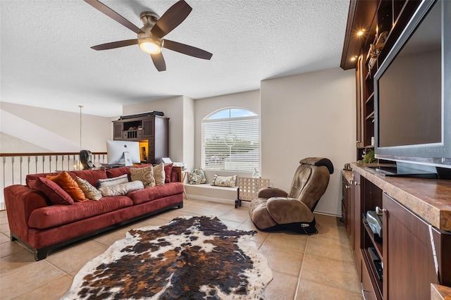 5321 Los Palma Vista Dr, Orlando, FL 32837 - living area featuring a ceiling fan, a textured ceiling, and light tile patterned floors
