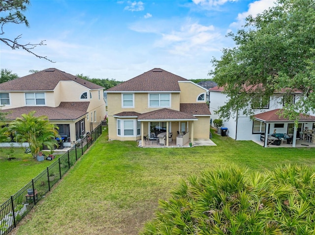 5321 Los Palma Vista Dr, Orlando, FL 32837 - back of house featuring a fenced backyard, roof with shingles, stucco siding, a patio area, and a lawn