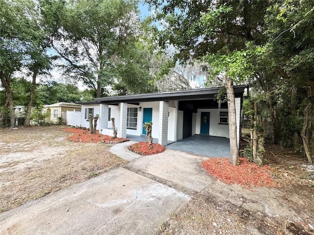 ranch-style home with an attached carport and concrete driveway