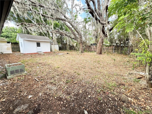 view of yard featuring an outdoor structure and a fenced backyard