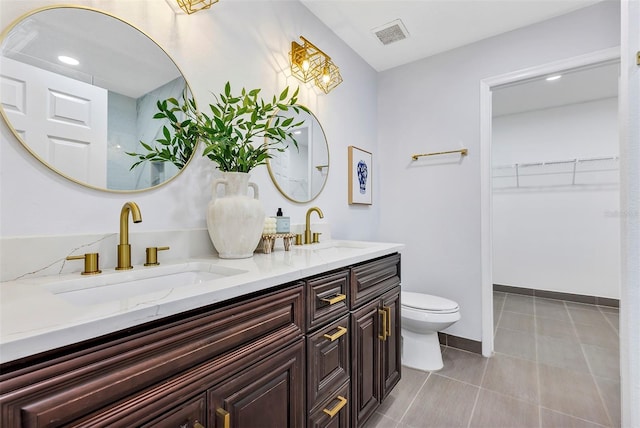 1176 Epson Oaks Way, Orlando, FL 32837 - bathroom featuring visible vents, a sink, double vanity, and toilet