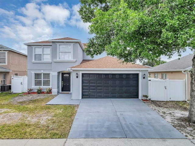 1176 Epson Oaks Way, Orlando, FL 32837 - traditional-style home featuring fence, stucco siding, a gate, an attached garage, and driveway