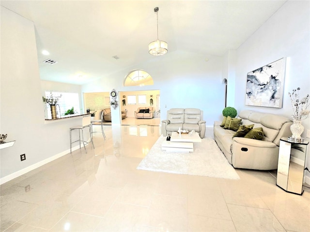 2346 Lily Pad Ln, Kissimmee, FL 34743 - living room with visible vents, baseboards, light tile patterned floors, and lofted ceiling