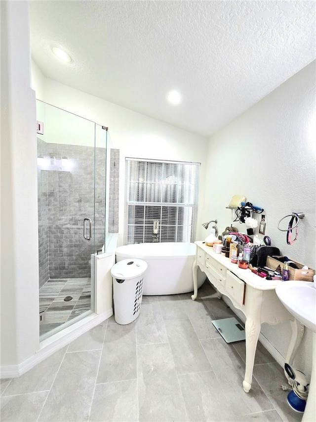 2346 Lily Pad Ln, Kissimmee, FL 34743 - bathroom featuring a textured ceiling, recessed lighting, a freestanding tub, lofted ceiling, and a stall shower
