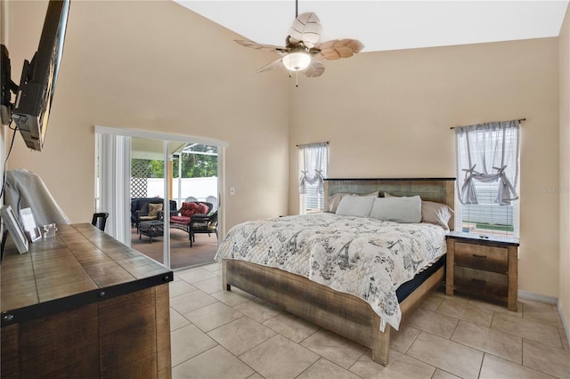 bedroom with access to outside, a high ceiling, ceiling fan, and light tile patterned flooring