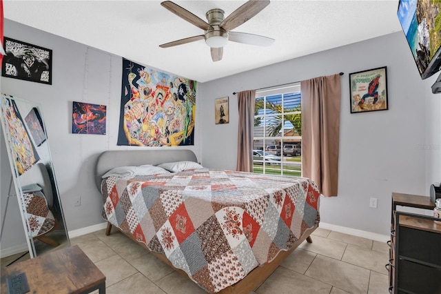 bedroom featuring baseboards, a ceiling fan, and light tile patterned flooring