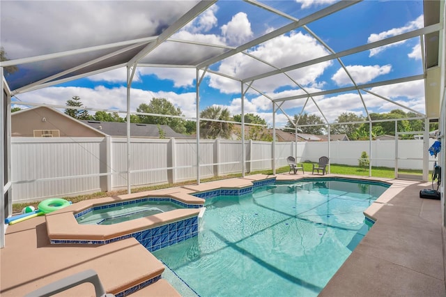 view of pool with a pool with connected hot tub, a lanai, and a fenced backyard