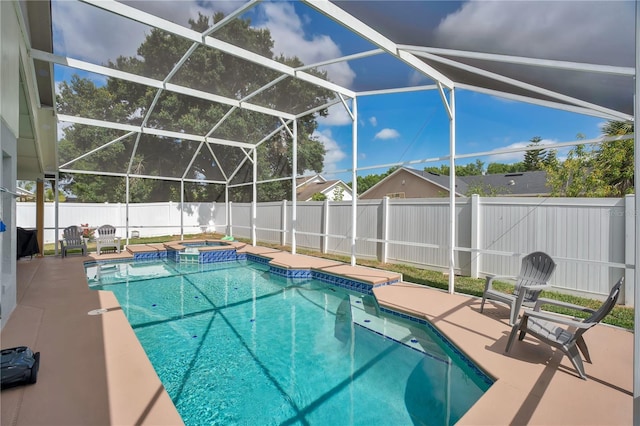 view of pool with glass enclosure, a pool with connected hot tub, a fenced backyard, and a patio area
