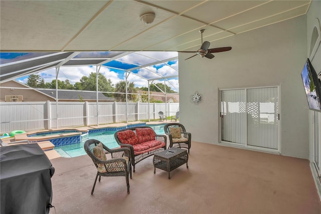 view of patio with a fenced backyard, a ceiling fan, a lanai, and a pool with connected hot tub