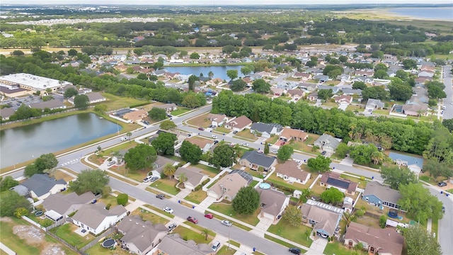 birds eye view of property with a water view and a residential view