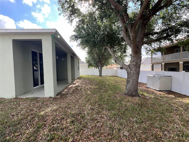 view of yard featuring fence and a patio