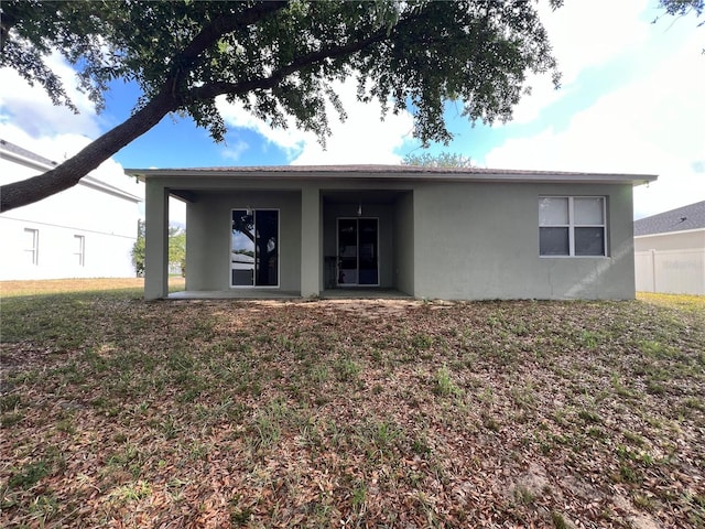 back of house with a patio and stucco siding