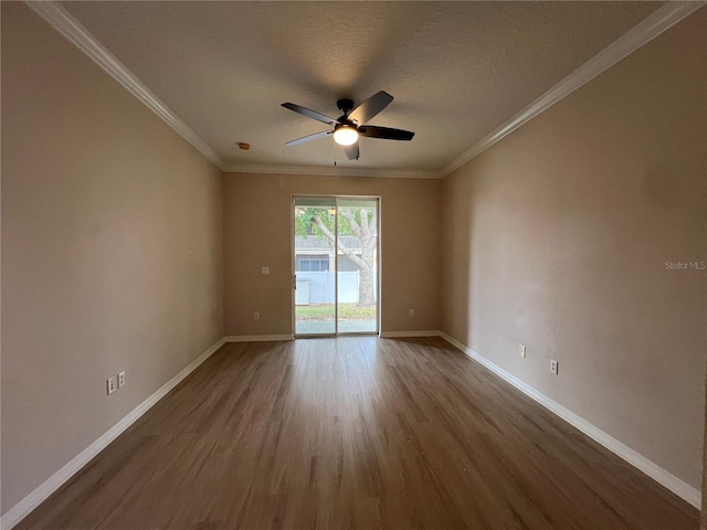 unfurnished room featuring crown molding, baseboards, ceiling fan, and dark wood-style flooring