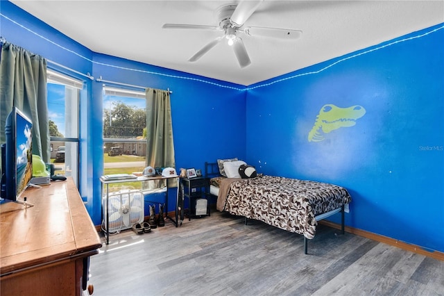 bedroom with a ceiling fan and wood finished floors