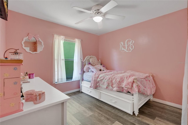 bedroom with baseboards, a ceiling fan, and wood finished floors