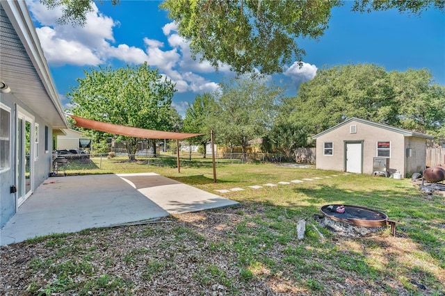 view of yard with a fenced backyard, a patio area, and an outbuilding