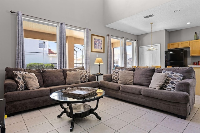 209 Rosso Dr, Davenport, FL 33837 - living area featuring light tile patterned floors and a textured ceiling
